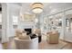 Bright living room with a fireplace, plush seating, and large windows overlooking the front yard at 2475 S Adams St, Denver, CO 80210