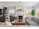 Bright living room features a fireplace, light hardwood floors, and stylish decor at 2475 S Adams St, Denver, CO 80210