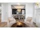 Bright living room featuring a view of the dining room, stylish armchairs, and hardwood floors at 2475 S Adams St, Denver, CO 80210
