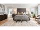 Luxurious main bedroom showcasing a tufted headboard, soft rug, and abundant natural light at 2475 S Adams St, Denver, CO 80210