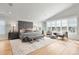 Spacious main bedroom features vaulted ceiling, large windows, and stylish furniture at 2475 S Adams St, Denver, CO 80210