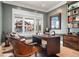 Stylish home office with a large window, hardwood floors, custom desk, and comfortable seating at 2475 S Adams St, Denver, CO 80210