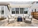 Charming outdoor patio area features stone flooring, comfortable seating, and a modern fire pit at 2475 S Adams St, Denver, CO 80210