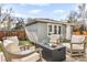 Inviting outdoor patio features stone flooring, comfortable seating, and a fire pit table at 2475 S Adams St, Denver, CO 80210