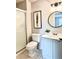 Bathroom featuring updated lighting, decor, a shower with glass doors and tile flooring at 18064 E Ohio Ave # 202, Aurora, CO 80017