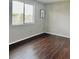 Bedroom featuring laminate floors, a large window with a view, and neutral wall paint at 18064 E Ohio Ave # 202, Aurora, CO 80017
