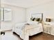 Bright bedroom with a large window and stylish decor at 18064 E Ohio Ave # 202, Aurora, CO 80017