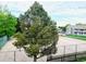 Community park view with mature trees, playground, and walking path at 18064 E Ohio Ave # 202, Aurora, CO 80017