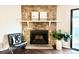 Close-up of the stone fireplace offering a classic aesthetic and inviting feel to the living space at 18064 E Ohio Ave # 202, Aurora, CO 80017