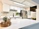 Modern kitchen with white cabinets, stainless steel appliances, and quartz countertops at 18064 E Ohio Ave # 202, Aurora, CO 80017