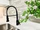 Kitchen features stainless steel faucet, quartz counters, and modern tile backsplash at 18064 E Ohio Ave # 202, Aurora, CO 80017