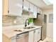 Bright kitchen features white quartz counters, stainless steel appliances, and tile backsplash at 18064 E Ohio Ave # 202, Aurora, CO 80017