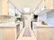 Bright kitchen with stainless steel appliances, white cabinets, quartz countertops, and a skylight at 18064 E Ohio Ave # 202, Aurora, CO 80017