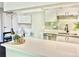 Bright kitchen with white cabinets, stainless appliances, stylish tile, and breakfast bar at 18064 E Ohio Ave # 202, Aurora, CO 80017
