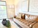 Bright living room features contemporary décor, a cozy sofa, and a balcony with natural light at 18064 E Ohio Ave # 202, Aurora, CO 80017