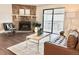 Comfortable living room with stone fireplace, sleek furniture, and a sliding glass door leading to the balcony at 18064 E Ohio Ave # 202, Aurora, CO 80017