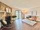 Inviting living room features a stone fireplace, modern furnishings, and sliding doors to a balcony at 18064 E Ohio Ave # 202, Aurora, CO 80017