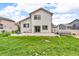 Backyard with large patio, hot tub, grass, and partially fenced yard at 5286 Rustic Ave, Firestone, CO 80504