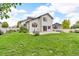 Expansive backyard with lush lawn, a concrete patio, and partial fencing at 5286 Rustic Ave, Firestone, CO 80504