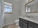 Updated bathroom with a white vanity, large mirror, and natural light at 5286 Rustic Ave, Firestone, CO 80504