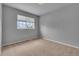 Bedroom with gray walls, carpeted floors and a bright window at 5286 Rustic Ave, Firestone, CO 80504
