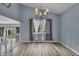 Bright dining room with wood floors, vaulted ceiling, and modern chandelier at 5286 Rustic Ave, Firestone, CO 80504