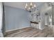 Open dining area with hardwood floors, modern lighting, and easy access to the kitchen and living spaces at 5286 Rustic Ave, Firestone, CO 80504