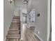 Inviting entryway with hardwood floors, staircase, and views into the dining and kitchen areas at 5286 Rustic Ave, Firestone, CO 80504