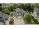 Aerial view of a two-story home boasting an attached three-car garage, and well-manicured landscaping at 5286 Rustic Ave, Firestone, CO 80504