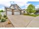 Charming two-story home with a three-car garage, stone accents, and well-manicured front yard at 5286 Rustic Ave, Firestone, CO 80504