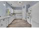 Bright kitchen with white cabinetry, marble countertops, modern appliances, and hardwood floors at 5286 Rustic Ave, Firestone, CO 80504