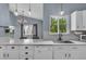Bright kitchen with white cabinetry, marble countertops, modern appliances, and hardwood floors at 5286 Rustic Ave, Firestone, CO 80504