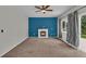 Bright living room with a fireplace and sliding glass doors to bring in the natural light at 5286 Rustic Ave, Firestone, CO 80504
