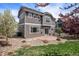 Backyard featuring a patio, rock landscaping, lawn, and multi-tone siding at 4307 Beautiful Cir, Castle Rock, CO 80109