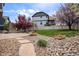 Backyard featuring a patio, rock landscaping, lawn, and white fence at 4307 Beautiful Cir, Castle Rock, CO 80109