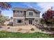 Backyard featuring a patio, rock landscaping, lawn, and multi-tone siding at 4307 Beautiful Cir, Castle Rock, CO 80109