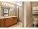Bathroom with double sink vanity, neutral tile flooring, and shower with curtain at 4307 Beautiful Cir, Castle Rock, CO 80109