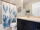 Bathroom featuring a tub and shower combo with flower curtain and neutral vanity at 4307 Beautiful Cir, Castle Rock, CO 80109