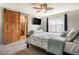 Serene main bedroom boasts a decorative barn door to the bathroom, soft carpeting, and ample natural light at 4307 Beautiful Cir, Castle Rock, CO 80109