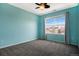 Bedroom with blue walls, a ceiling fan, carpeted floors and natural light at 4307 Beautiful Cir, Castle Rock, CO 80109