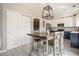 Bright dining area with a modern light fixture, stylish table set and view into kitchen at 4307 Beautiful Cir, Castle Rock, CO 80109