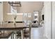 Stylish dining area with a modern table set, fireplace, view of the living room and backyard at 4307 Beautiful Cir, Castle Rock, CO 80109