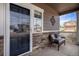 Inviting front porch with stone accents, a comfortable chair, and a view of the neighborhood at 4307 Beautiful Cir, Castle Rock, CO 80109