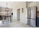 Open-concept kitchen featuring stainless steel refrigerator, dining area, and seamless flow to the living spaces at 4307 Beautiful Cir, Castle Rock, CO 80109