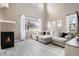 Inviting living room with a cozy fireplace, large window, comfortable seating and lots of light at 4307 Beautiful Cir, Castle Rock, CO 80109