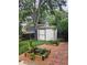 Backyard shed with a stone path and surrounding garden boxes at 9749 Meade Cir, Westminster, CO 80031