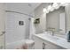 Bright bathroom features a shower over tub with subway tile, a modern vanity and neutral paint at 9749 Meade Cir, Westminster, CO 80031