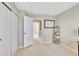 Bright bedroom featuring neutral paint, sliding closet, and an open doorway to the hallway at 9749 Meade Cir, Westminster, CO 80031