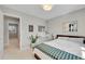 Bright bedroom features a large window, neutral paint, and a bed with a patterned blanket at 9749 Meade Cir, Westminster, CO 80031