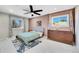 Cozy bedroom with neutral walls, plush carpet, ceiling fan and natural light from two windows at 9749 Meade Cir, Westminster, CO 80031